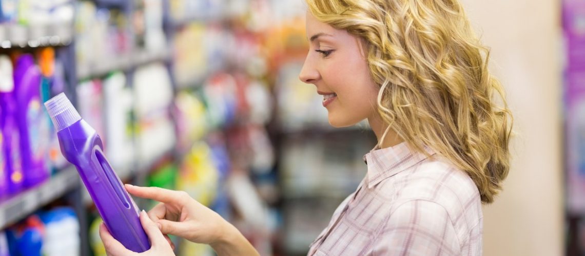 Side view of smiling pretty blonde woman looking at a product in supermarket,Image: 253487244, License: Royalty-free, Restrictions: , Model Release: yes